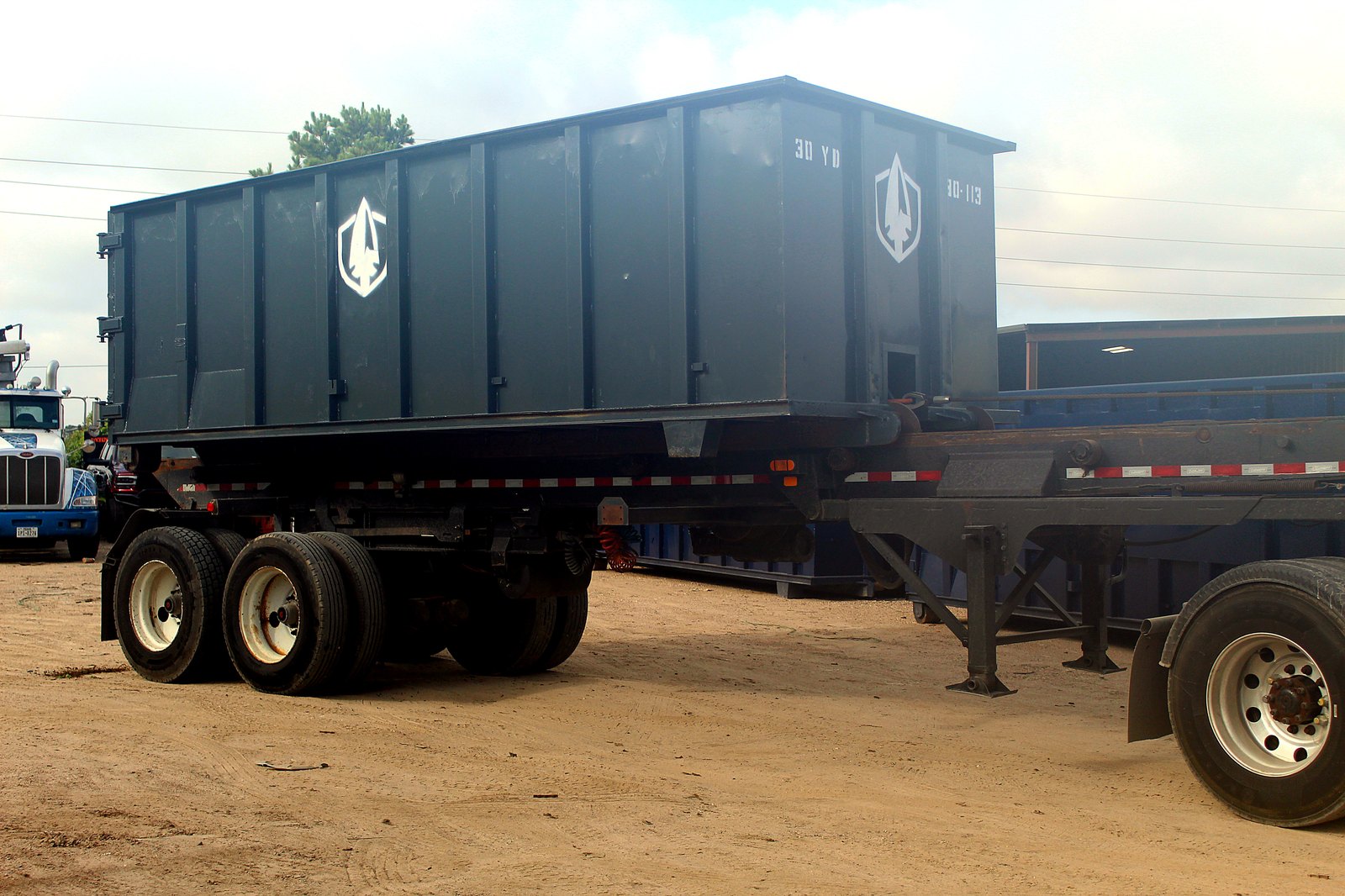 Spartan Metals 30 yard roll-off container loaded on a trailer