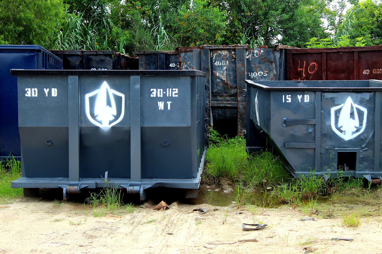 Row of Spartan Metals roll-off containers staged in the yard