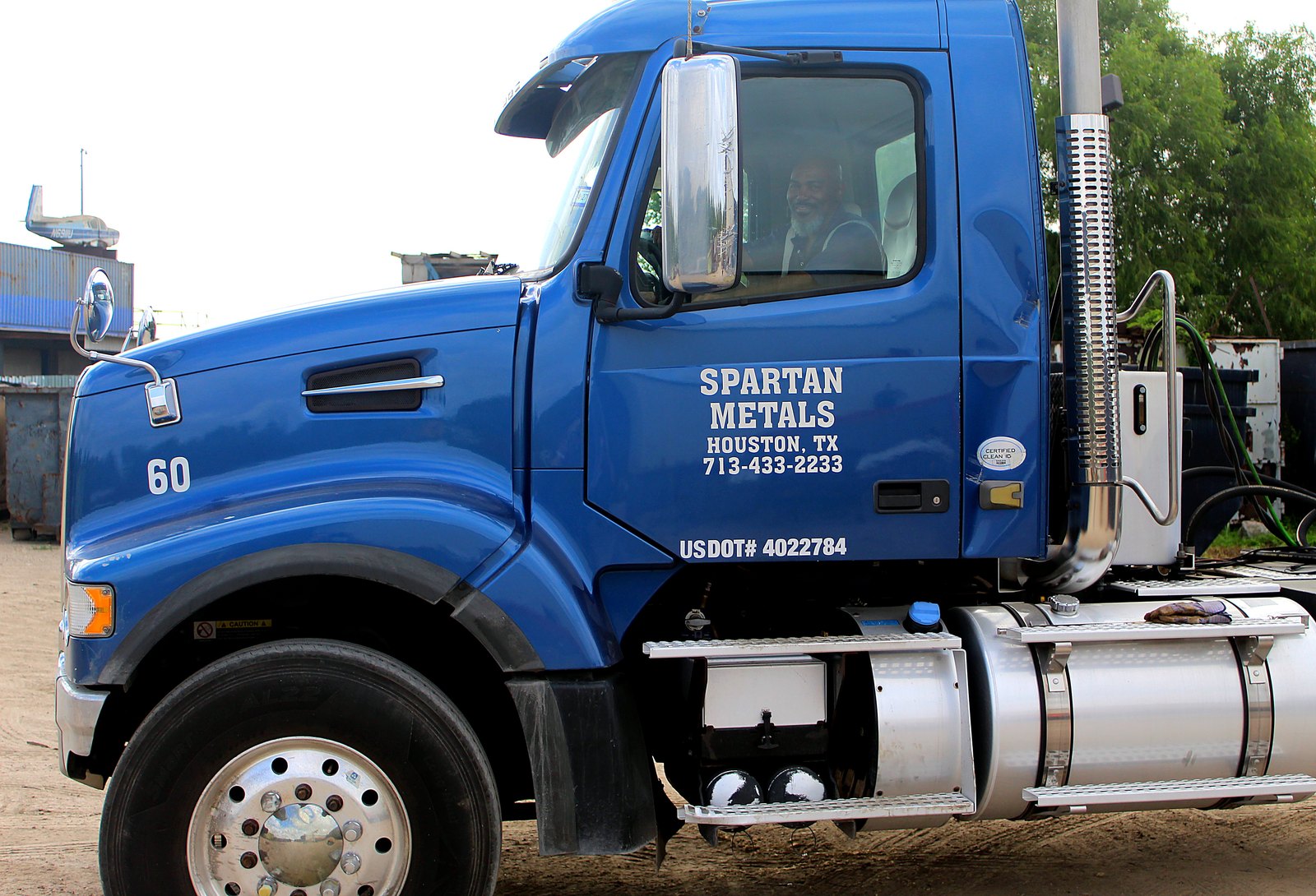 Side of a Spartan Metals truck cab showing the Houston, TX phone number and USDOT number